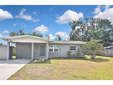 Charming single-story home featuring a carport, a well-maintained lawn, and freshly painted exterior at 5905 Olive Ave, Sarasota, FL 34231