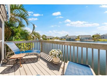 Waterfront deck with lounge chairs and views of the surrounding community at 1211 Spoonbill Landings Cir, Bradenton, FL 34209