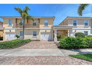 Charming townhome featuring a private garage, covered parking, balcony, and lush landscaping at 1831 Burgos Dr, Sarasota, FL 34238