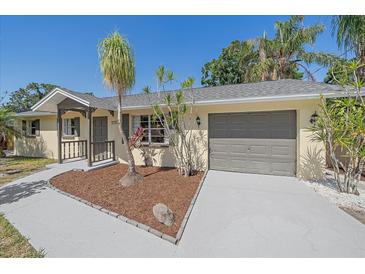 Charming single-story home with a well-manicured lawn and a neutral color palette at 2226 Fairfield Ave, Sarasota, FL 34232
