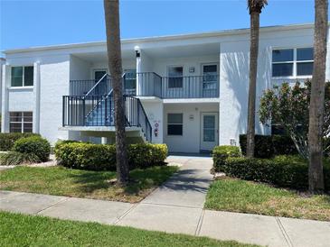 Inviting condo building with well-maintained landscaping, fresh paint, and bright sunny exposure at 725 Capri Isles Blvd # 217, Venice, FL 34292