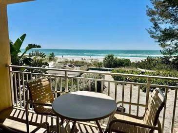 Balcony view overlooking the beach with patio furniture to enjoy the ocean views at 2412 N Gulf Dr # 119, Bradenton Beach, FL 34217