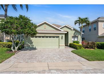Charming single-Gathering home showcasing a lush lawn and welcoming two-car garage at 3740 Summerwind Cir, Bradenton, FL 34209