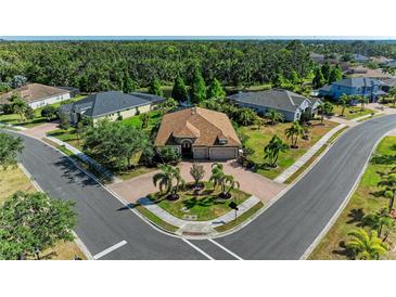 Stunning property featuring lush landscaping, brick paved driveway and a beautiful natural backdrop at 5439 74Th E Pl, Ellenton, FL 34222