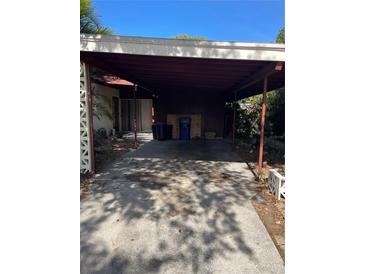 A covered carport with concrete floor provides parking and protection from the elements at 5820 24Th W St, Bradenton, FL 34207