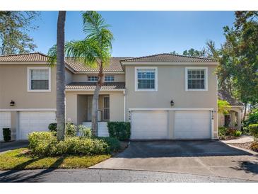Charming townhome with attached garages, manicured landscaping, and a tile roof at 6748 Fairview Ter # 4-202, Bradenton, FL 34203
