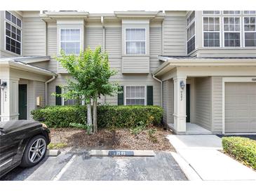 Inviting townhome exterior with a well-manicured lawn and private parking at 7593 Plantation Cir, Bradenton, FL 34201