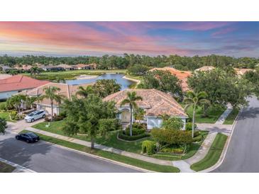 Stunning single Gathering home featuring mature landscaping and a beautiful barrel tile roof at 1311 Tuscany Blvd, Venice, FL 34292