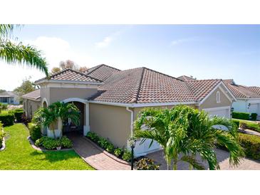 Tile roof and well-maintained landscaping add beauty to the exterior of this lovely tan stucco home at 1503 Calle Grand St, Bradenton, FL 34209