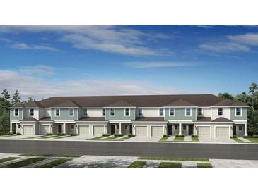 Charming townhome exteriors with a light blue and white palette and convenient attached garages at 15180 Cuzcorro Ct, Nokomis, FL 34275