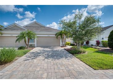 Charming single-story home featuring a paver driveway, two-car garage, and well-maintained landscaping at 2945 Trustee Ave, Sarasota, FL 34243