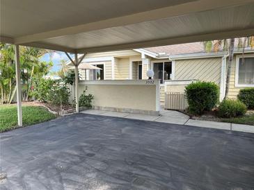 Residential property featuring a covered carport and walkway leading to the entrance at 3002 Sail Pointe Cir # 1B, Venice, FL 34293