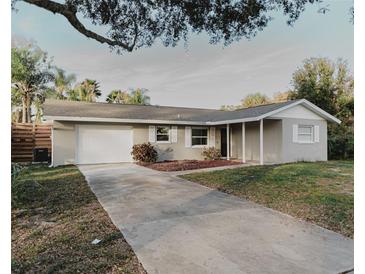 Charming single-story home with a one-car garage and well-maintained front yard at 4549 Mcintosh Ln, Sarasota, FL 34232