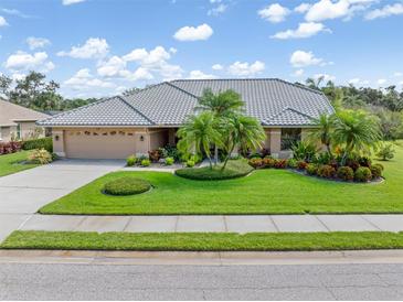 Charming home with lush landscaping, circular driveway and beautiful tile roof at 4625 Deer Creek Blvd, Sarasota, FL 34238