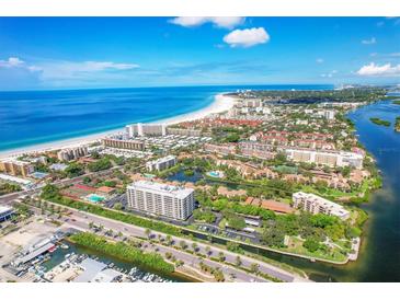 Panoramic aerial view of beachfront condos, blue ocean, and intercoastal waterway on a sunny day at 6415 Midnight Pass Rd # 710, Sarasota, FL 34242