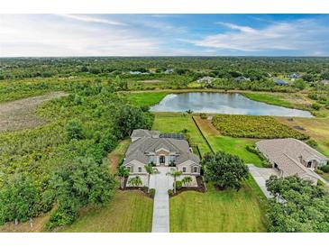 Expansive waterfront home featuring lush landscaping, mature trees and scenic views at 8103 Snowy Egret Pl, Bradenton, FL 34202