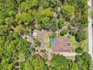 Secluded home with mature trees, a pool, and a spacious yard perfect for relaxing and enjoying the outdoors at 18026 Nutcracker Rd, Weeki Wachee, FL 34614
