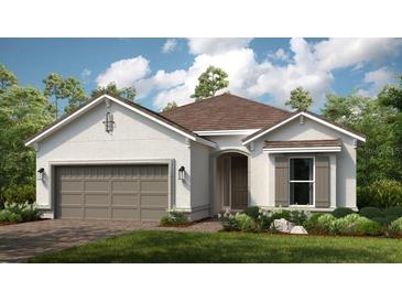 Charming single-story home with a well-manicured lawn, two car garage, and classic architectural details at 3607 Santa Caterina Blvd, Bradenton, FL 34211