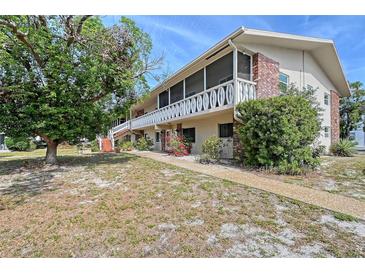 Charming two-story condo with screened balcony and lush landscaping, offering a serene outdoor space at 3705 S School Ave # 3, Sarasota, FL 34239
