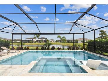 Screened-in pool and spa overlooking the water create a relaxing backyard oasis at 5117 Marina Basin Ct, Bradenton, FL 34211