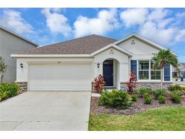 Charming single-story home featuring a two-car garage, well-maintained landscaping, and a welcoming front entrance at 5121 Sultana Cv, Bradenton, FL 34211