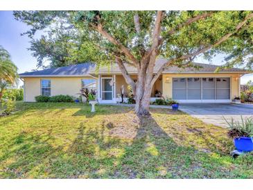 Charming single-story home with a well-manicured lawn and mature tree in a quiet residential neighborhood at 9366 Westminster Ave, Englewood, FL 34224