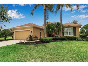 Charming single-story home features a lush lawn, mature landscaping, and a two-car garage at 1542 Ormond Ter, Parrish, FL 34219