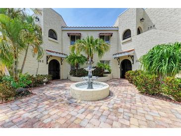Inviting courtyard featuring a decorative fountain, tropical landscaping, and charming brick pavers leading to the entrances at 6101 34Th W St # 28E, Bradenton, FL 34210