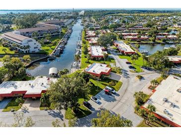 Expansive aerial view of waterfront community with docks, lush landscaping, and waterway access to the ocean at 9409 Catalina Dr, Bradenton, FL 34210