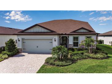 Charming single-Gathering home with a well-manicured lawn and beautiful landscaping at 10414 Spring Tide Way, Parrish, FL 34219