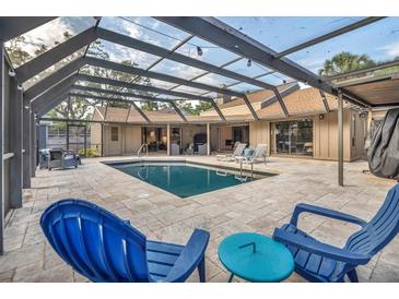 Inviting covered pool and patio area features in-ground pool and outdoor furniture at 1809 Buccaneer Ter, Sarasota, FL 34231