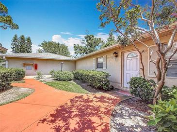 Exterior home view, featuring front door, manicured bushes, and landscaped walkway at 2188 Corinne S Ct # A, St Petersburg, FL 33712