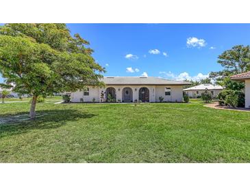 Charming single-story home with a well-manicured lawn and beautiful landscaping at 445 Matisse S Cir # 445, Nokomis, FL 34275