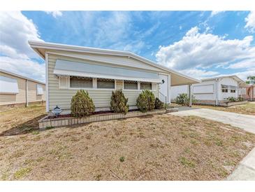 Charming single-story home featuring a covered carport and well-maintained landscaping at 5619 Bayshore Rd # 164, Palmetto, FL 34221