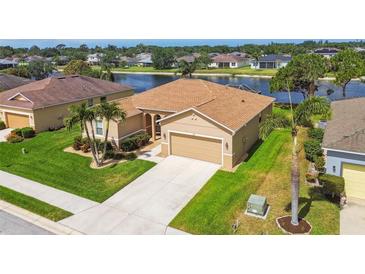 Beautiful single Gathering home showcasing a well-manicured lawn and picturesque waterfront views at 327 64Th Avenue E Cir, Bradenton, FL 34203