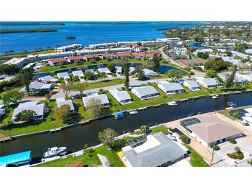 Panoramic aerial view of waterfront homes with canal access to bay and community amenities at 4726 Potomac Cir, Bradenton, FL 34210