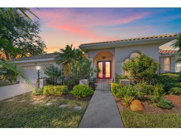 Charming single-story home featuring a red front door, well-maintained landscaping, and an inviting walkway at 4978 Cedar Oak Way, Sarasota, FL 34233