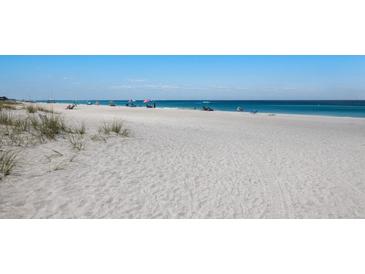 Wide sandy beach with tranquil ocean views, perfect for relaxation and recreation at 7000 Gulf Dr # 205, Holmes Beach, FL 34217
