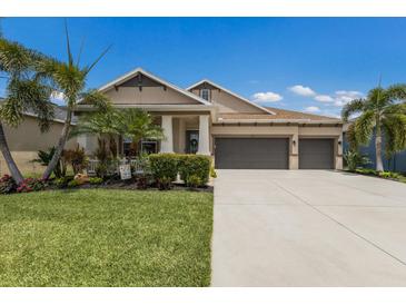 Beautiful home featuring a three-car garage, manicured landscaping, and a welcoming front porch at 11513 11Th E Ave, Bradenton, FL 34212