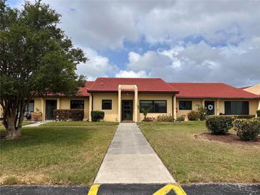 Charming single-story villa with well-maintained landscaping and a vibrant red tile roof at 1214 56Th W St # 1214, Bradenton, FL 34209