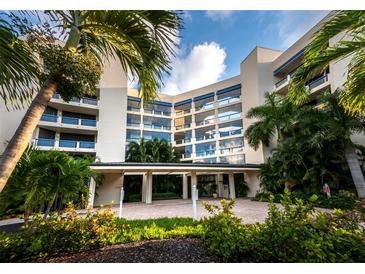 Beautiful condominium building surrounded by lush tropical landscaping and sunny skies at 2120 Harbourside Dr # 617, Longboat Key, FL 34228