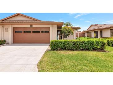 Charming single-Gathering home features an attached two-car garage and manicured front lawn at 4471 Atwood Cay Cir # 13, Sarasota, FL 34233
