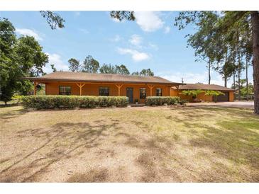 Charming ranch-style home with a covered porch and mature landscaping offering great curb appeal at 5204 24Th E Ave, Palmetto, FL 34221