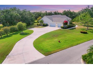 Stunning single-story home featuring a long driveway and lush landscaping, providing excellent curb appeal at 6102 9Th Avenue Cir Ne, Bradenton, FL 34212