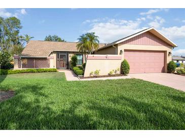 Charming home with a well-manicured lawn and a quaint front entrance at 6675 Easton Dr, Sarasota, FL 34238