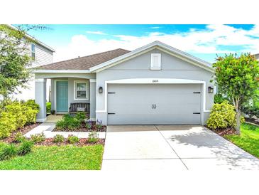 Charming single-Gathering home with a well-manicured lawn, features a two-car garage, and a welcoming front entrance at 11015 High Noon Trl, Parrish, FL 34219