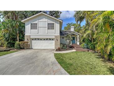 Charming two-story home featuring a well-maintained front yard and attached two car garage at 4514 Trails Dr, Sarasota, FL 34232