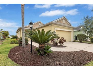 Inviting single-Gathering home featuring beautiful landscaping and an attached two-car garage at 11835 Crawford Parrish Ln, Parrish, FL 34219