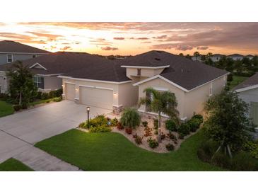 Beautiful single-Gathering home with a three car garage and a well manicured lawn in a sunny neighborhood at 16807 Barnwood Pl, Bradenton, FL 34211