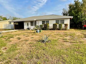 Charming single-story home featuring a covered carport, and a simple yard at 1905 Yale Ave, Bradenton, FL 34207